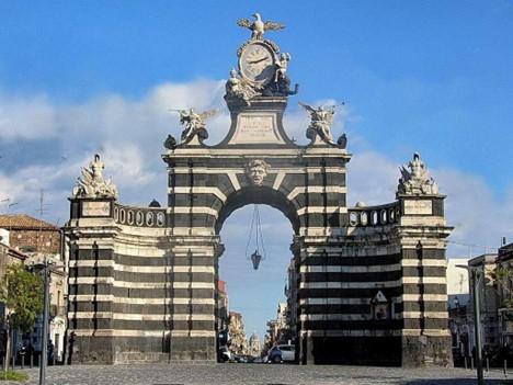 Porta Garibaldi, also called Porta Ferdinandea or "Fortino". Adorned with statues of angels and lions, and topped with a large clock, it is a striking sight on the cobblestone streets of Catania. ®FAI